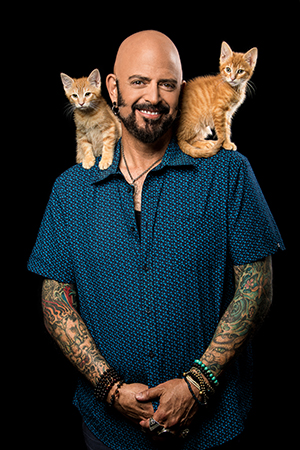 Jackson Galaxy with two kittens on his shoulders